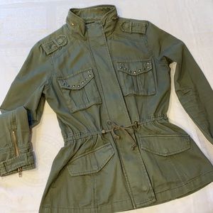 Green studded jacket with cinched waist option and zipper front. Size small.